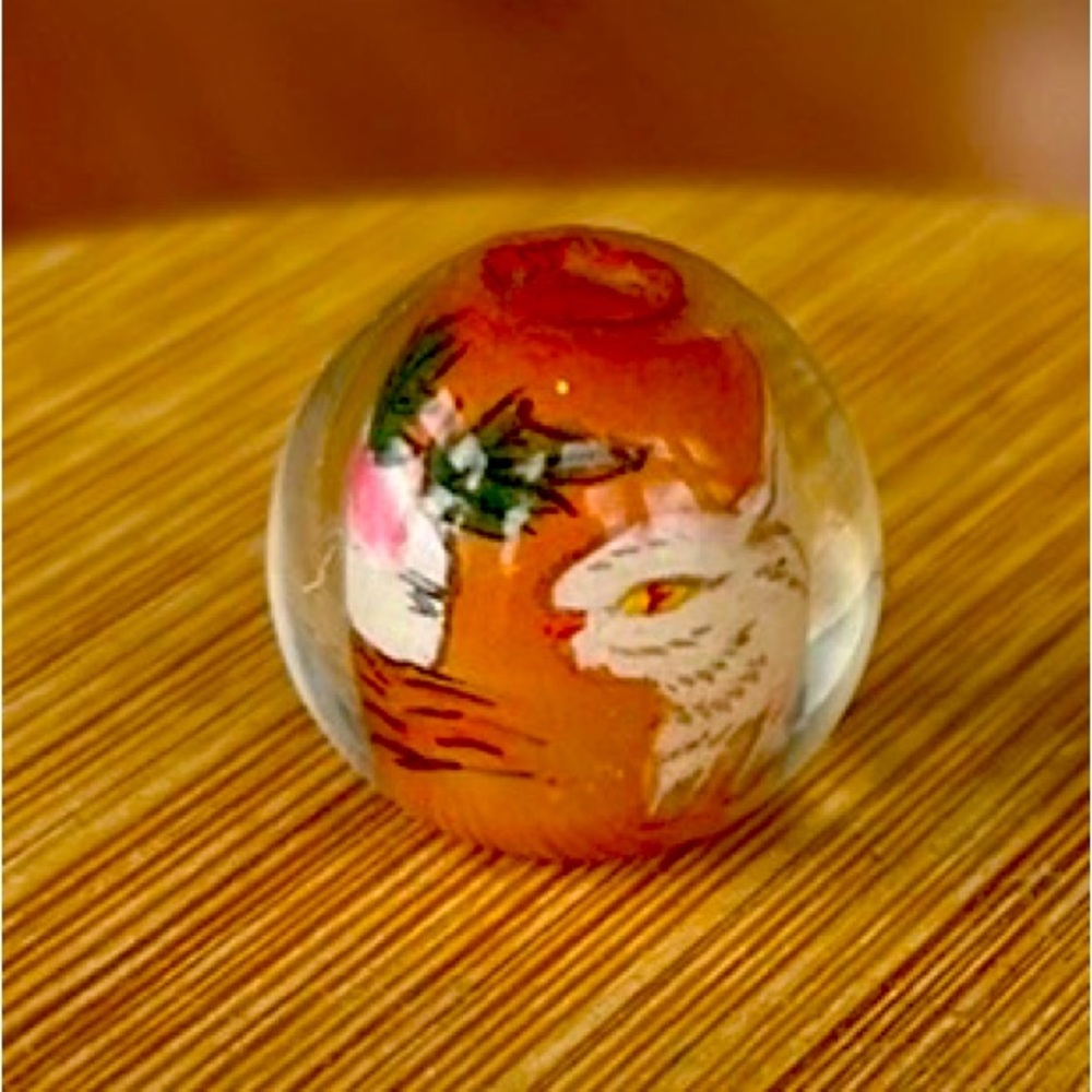 Reverse painted glass, bead, half inch diameter with white bunny in the garden